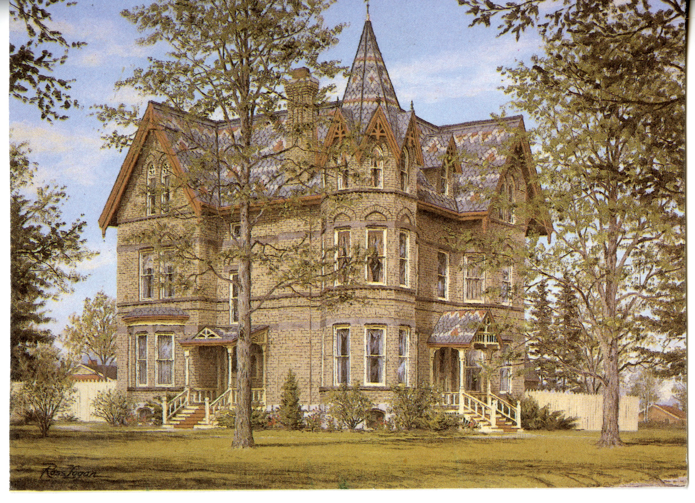 A postcard of Annandale House. The house partially obscured by trees, sky is blue with a few white clouds. It is a large, three-storey, yellow brick house with a tower on the one corner. The roof is shingled with gray, white, and red shingles a zig-zagging pattern. It is a very elaborate and grand home.
